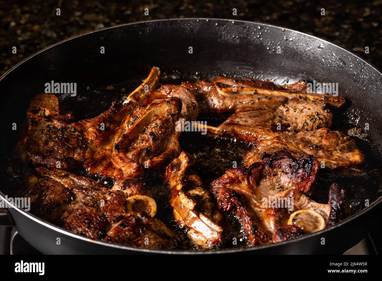Cooking lamb loin chops in a frying pan. Cooking on a gas stove Stock