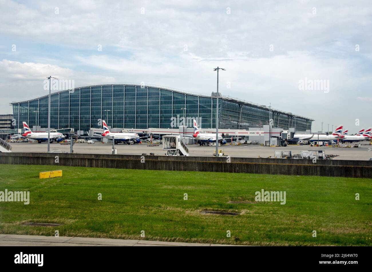 London, UK - April 19, 2022: Stands full of British Airways planes at the main Terminal 5 building at London's Heathrow Airport on a sunny spring morn Stock Photo