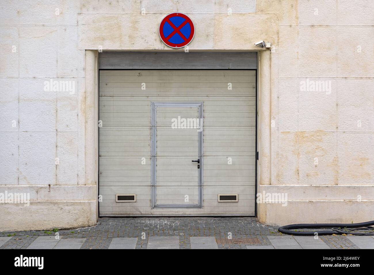 Automated Garage Roll Doors With Small Door Entrance Built in Stock Photo