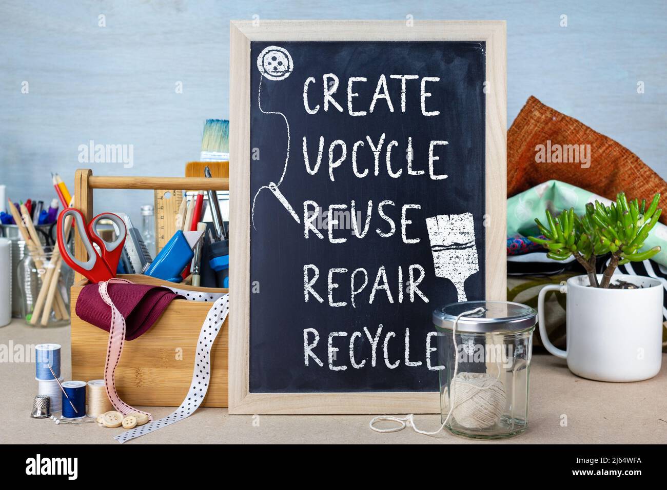 Create upcycle Repair Reuse Recycle sign with tools and fabric, reduce waste for sustainable living concept Stock Photo