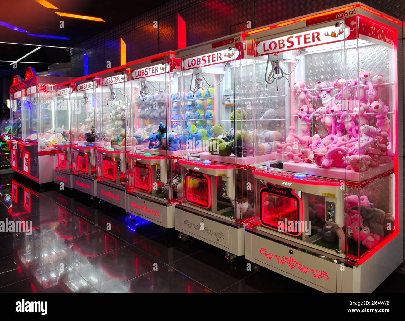 Kuala Lumpur,Malaysia - April 25,2022 : Colorful arcade game toy claw crane machine where people can win toys and other prizes. Stock Photo