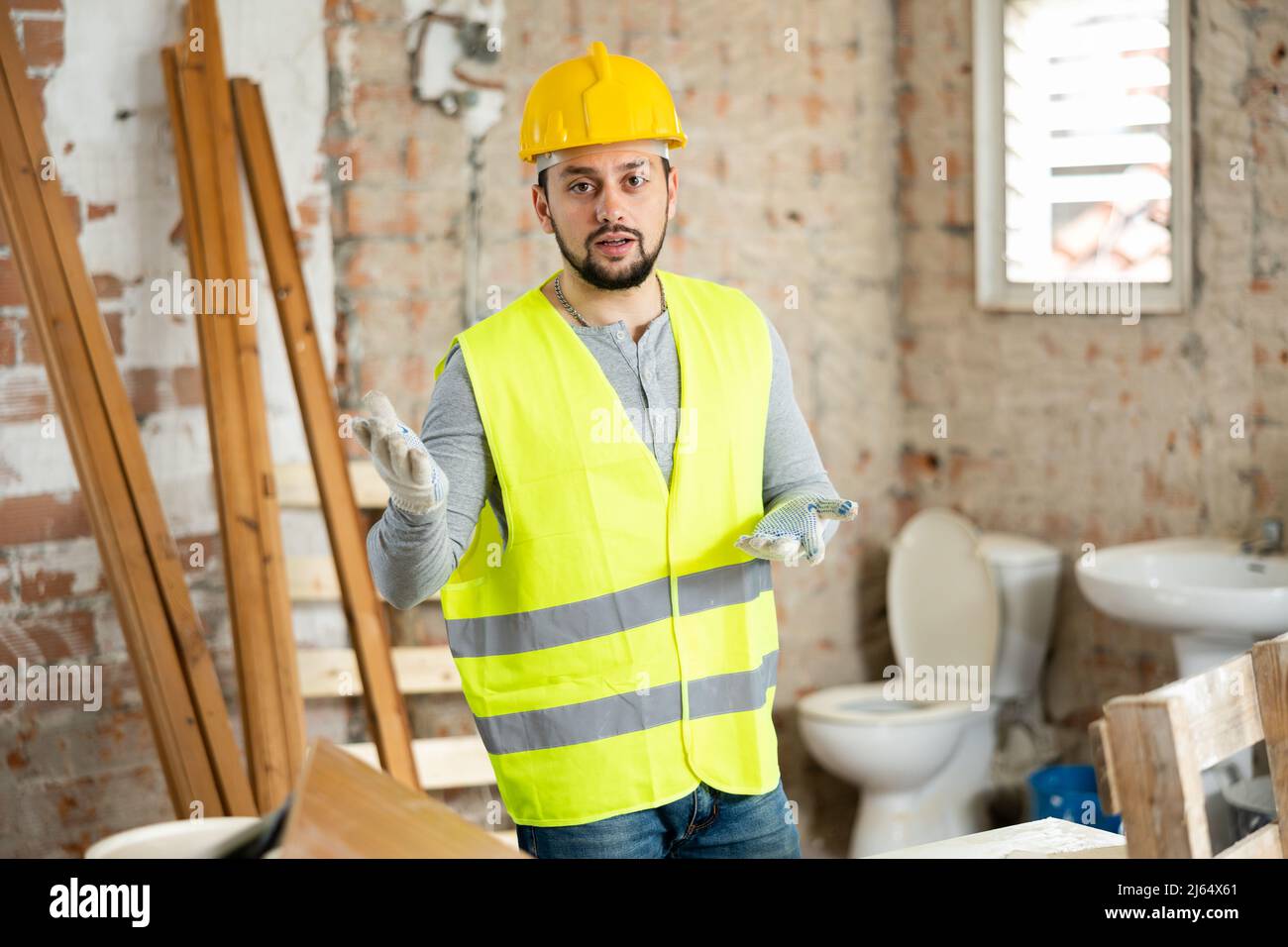 Young foreman discussing building renovation plan with customer Stock Photo