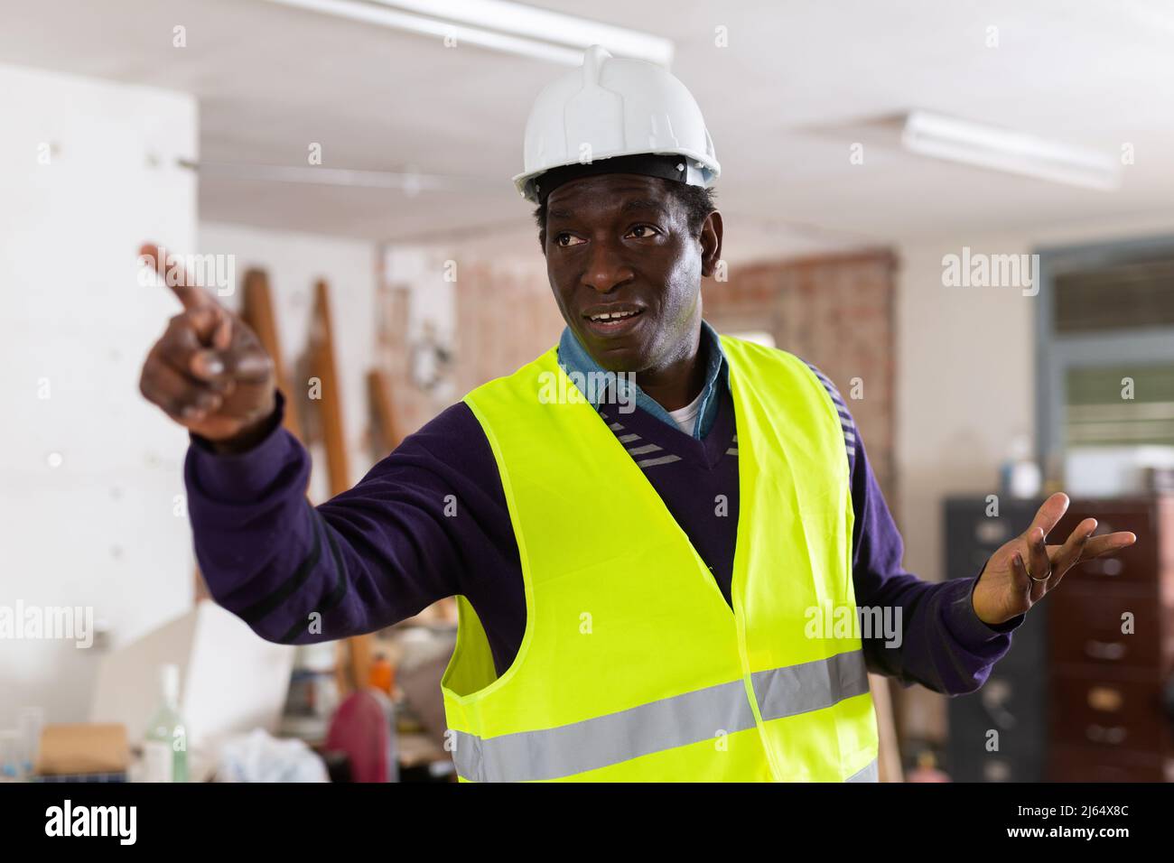 Portrait of african-american man engineer pointing finger Stock Photo ...