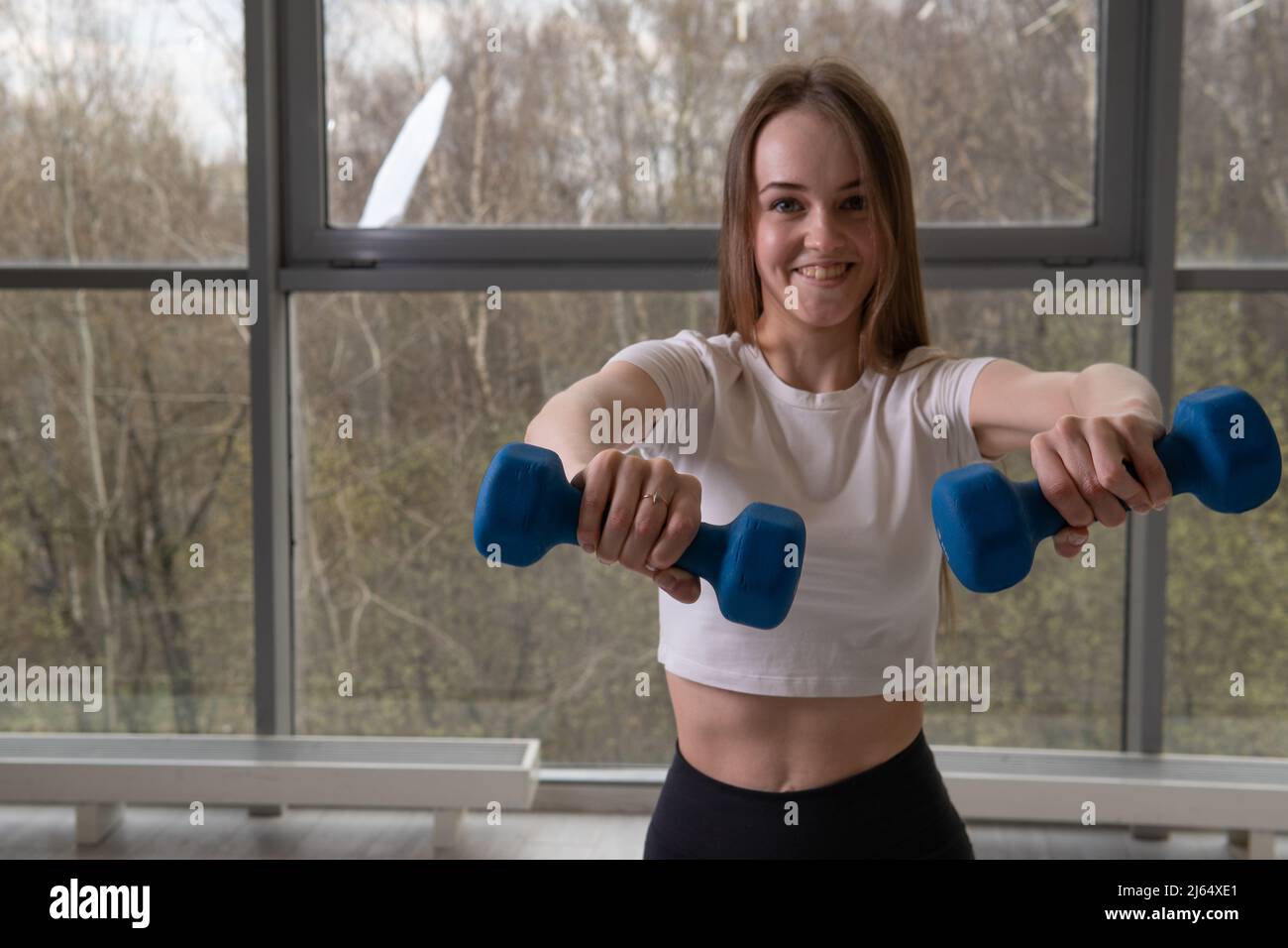 Girl sports dumbbells fitness body female young exercise fit, concept  healthy lifestyle sport person from isolated and squat pilates, human  strength Stock Photo - Alamy