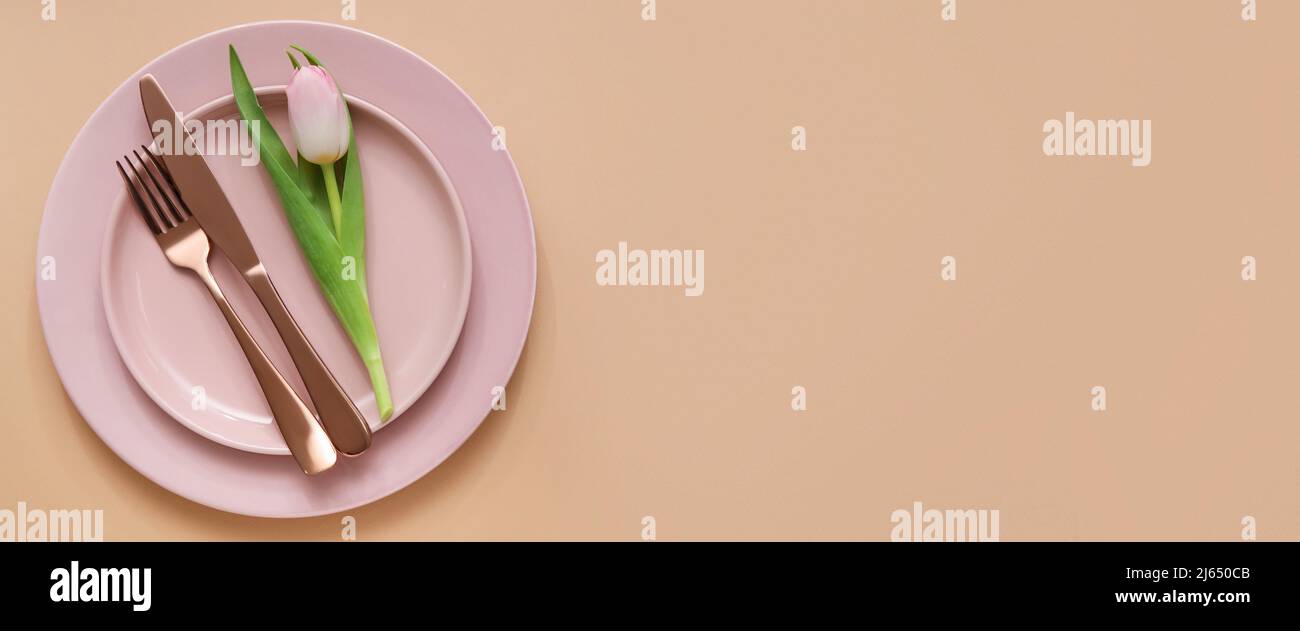 Simple spring table setting on beige background with space for text ...