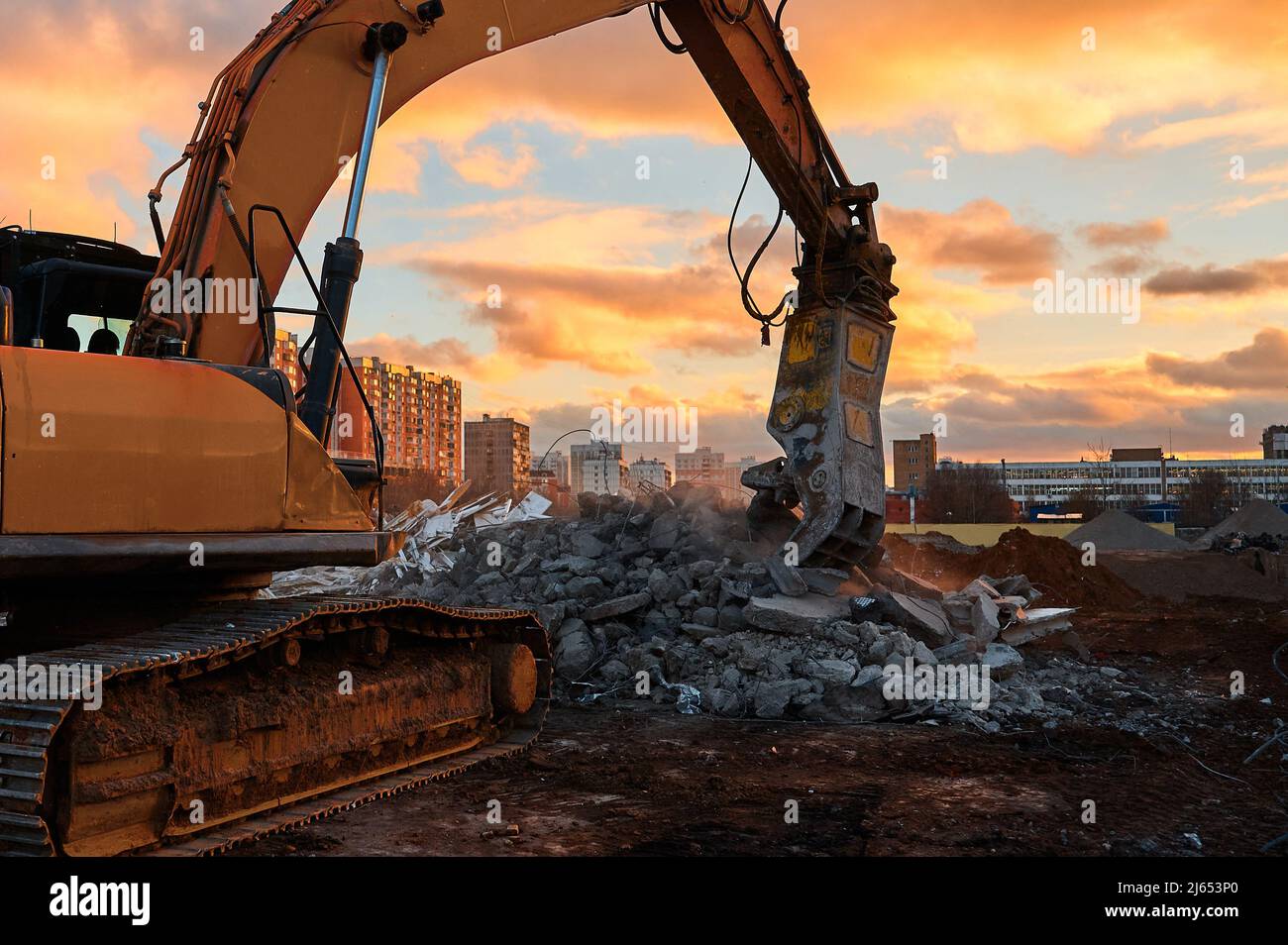 Excavator with concrete crusher on rig at demolition site Stock Photo ...