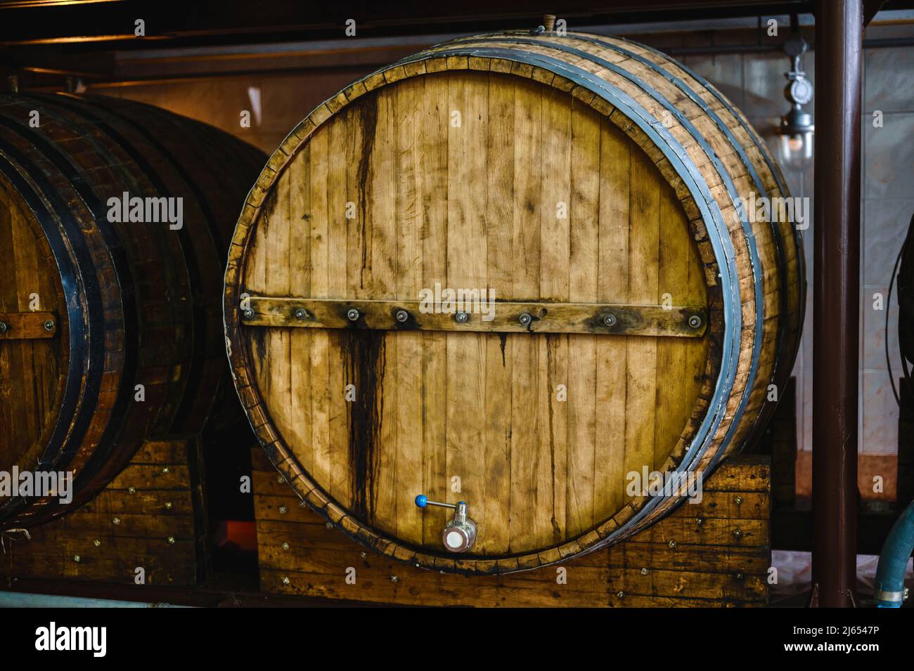 Wooden cask to make luxury alcohol drinks stand in cellar Stock Photo