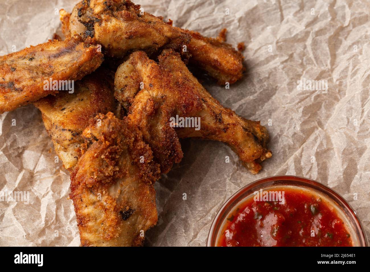 Fried Chicken Wings Covered in True Hot BBQ Sauce served with red hot