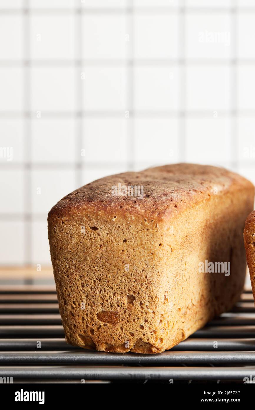 The process of making rye bread. The finished bread is taken out of the