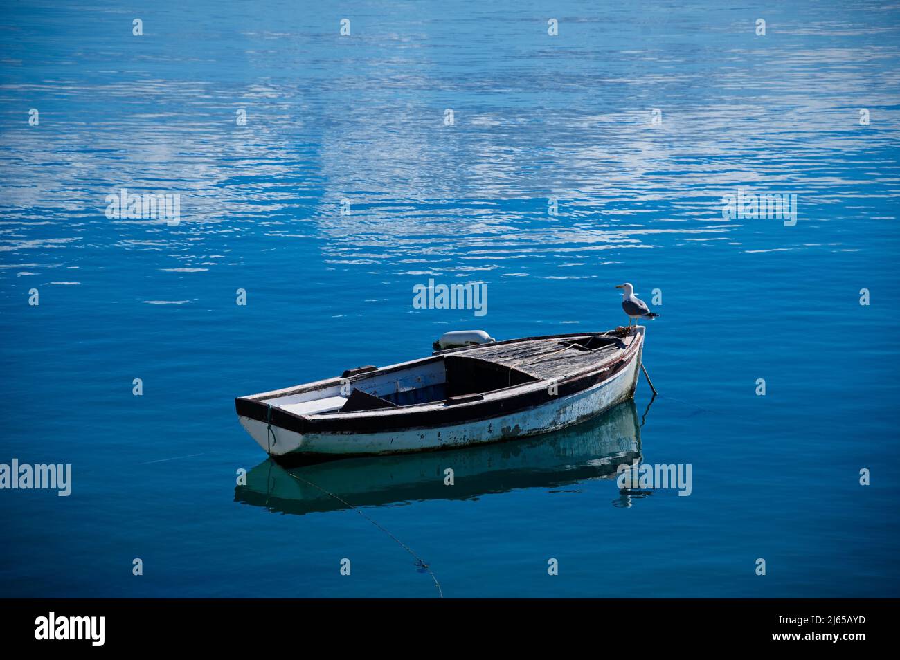 old wooden fishing boat reflected on water at a small lake pond Alimos  Greece Stock Photo - Alamy