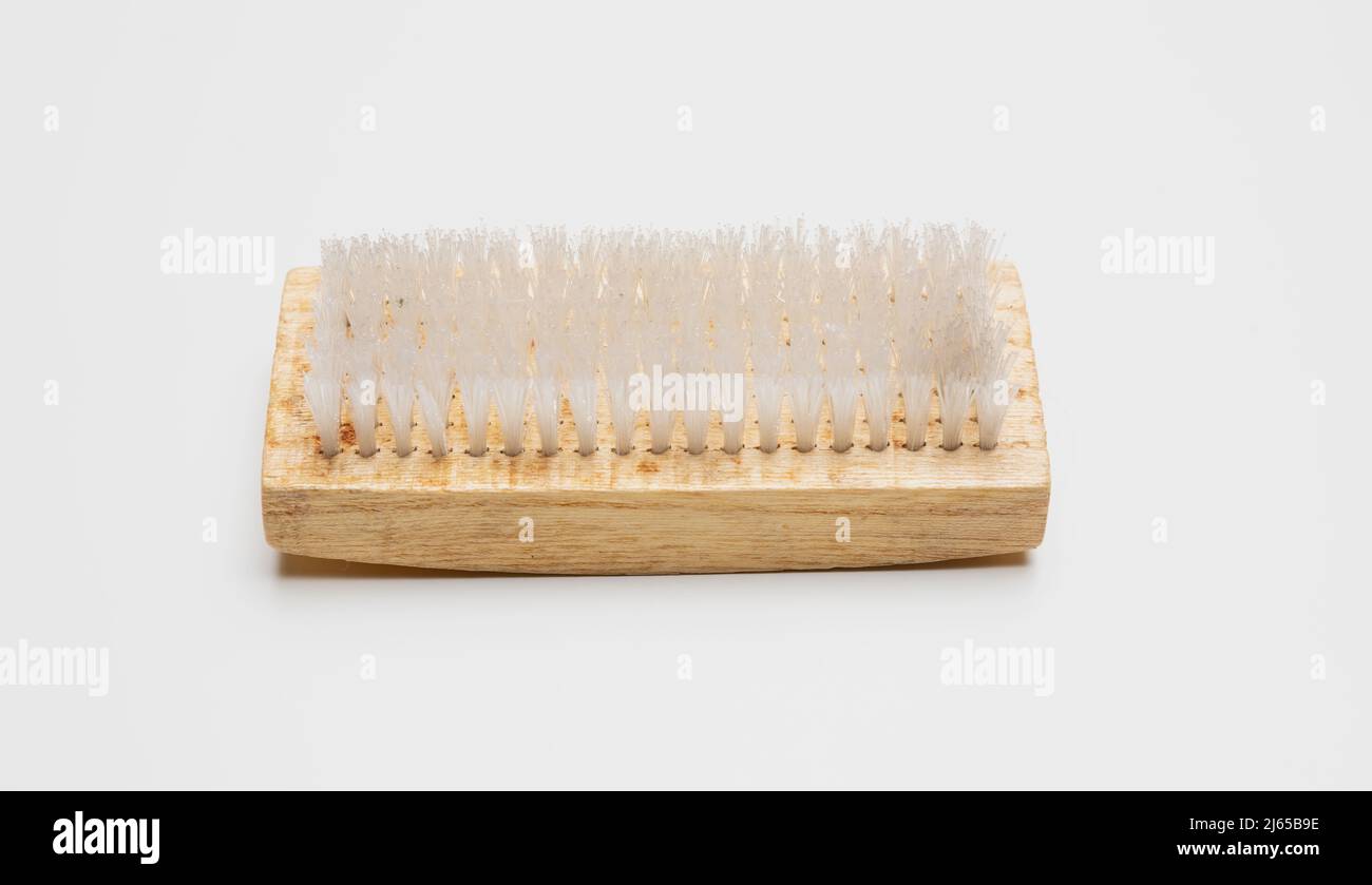 Wooden cleaning brush isolated cutout on white background. Cloth and carpet domestic scrub brush with nylon bristle. Overhead view. Stock Photo