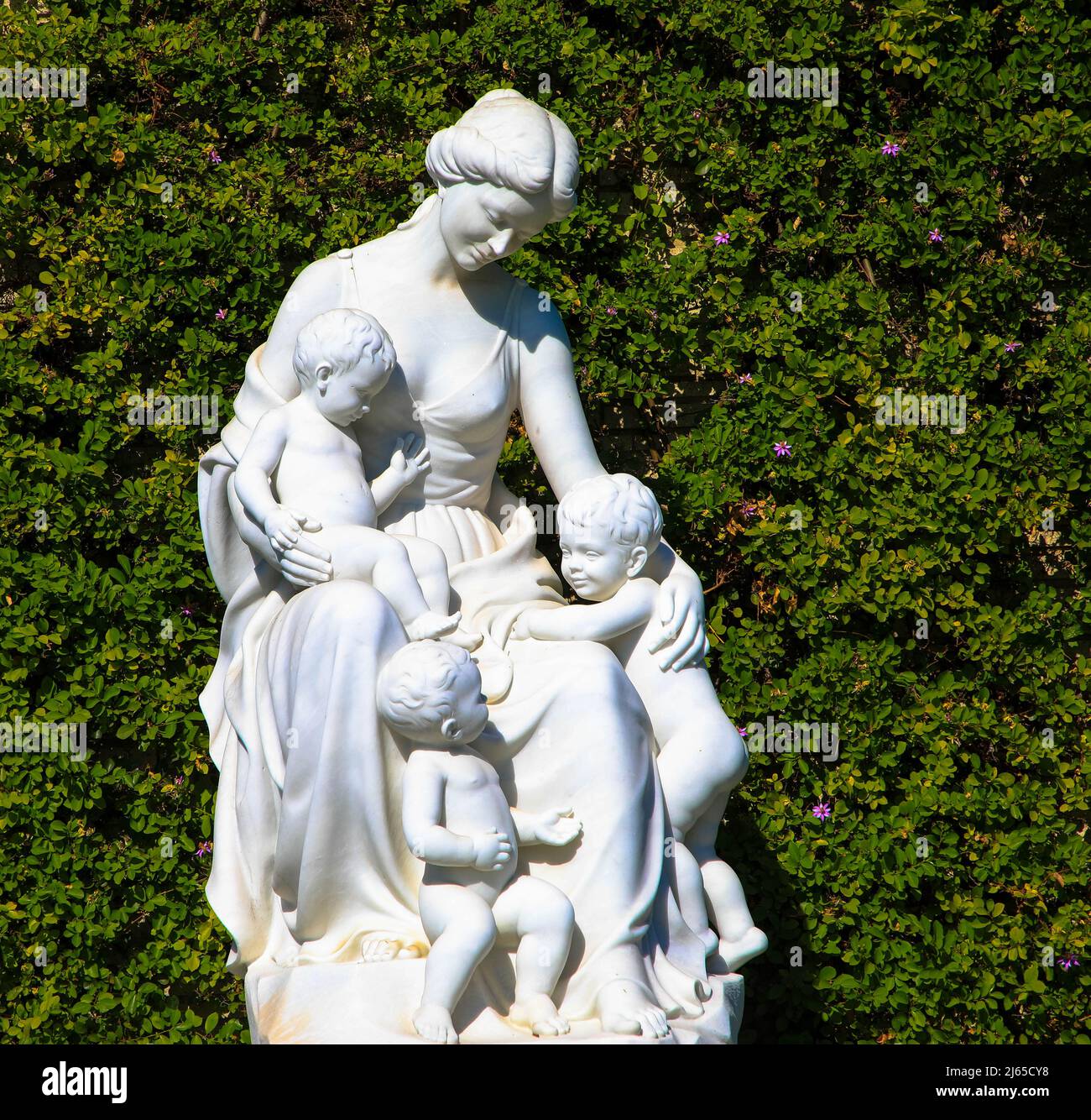 Magnificent plaster statue of a woman against green Background. Symbol ...