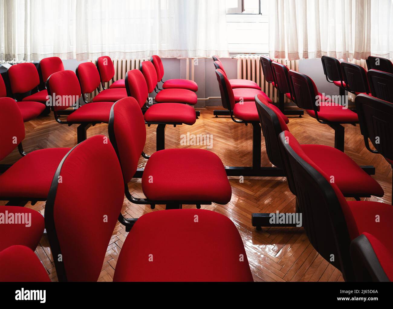 Interior of a classroom with red chairs. Stock Photo