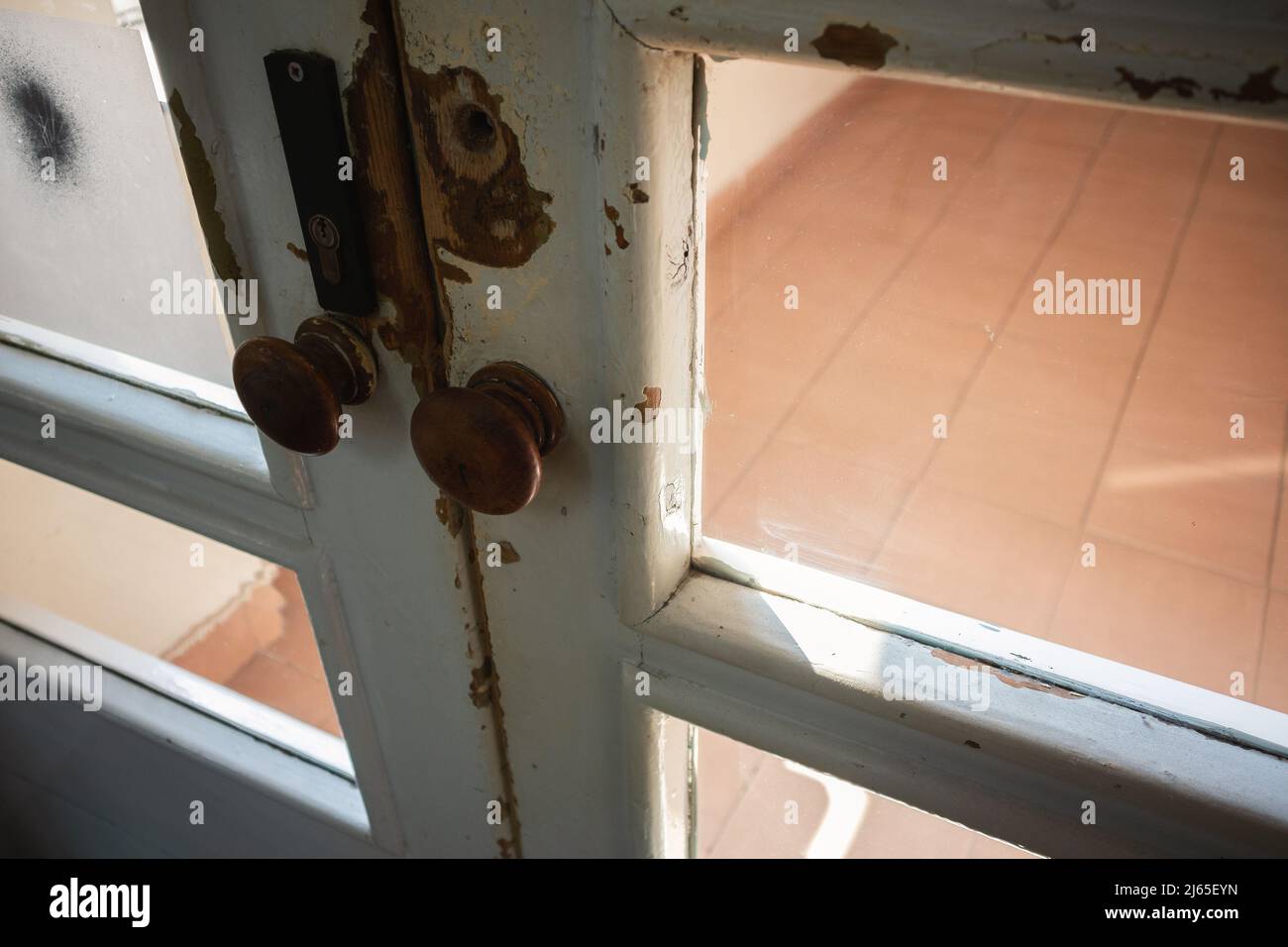 Details of an old white wooden door in an old hall. Stock Photo