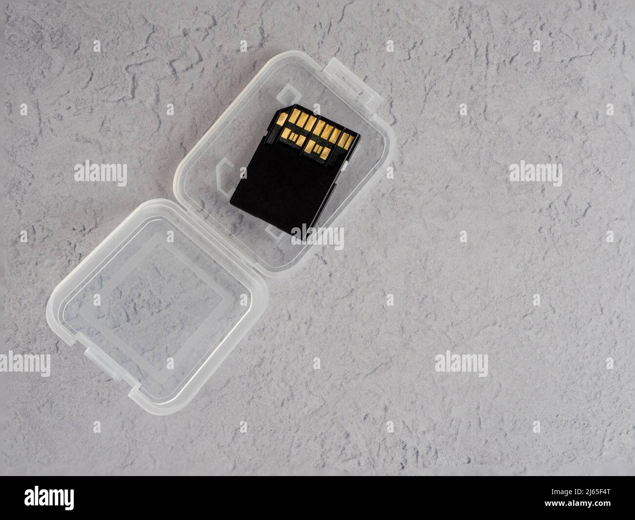 close up of an open white transparent memory card case with insert for