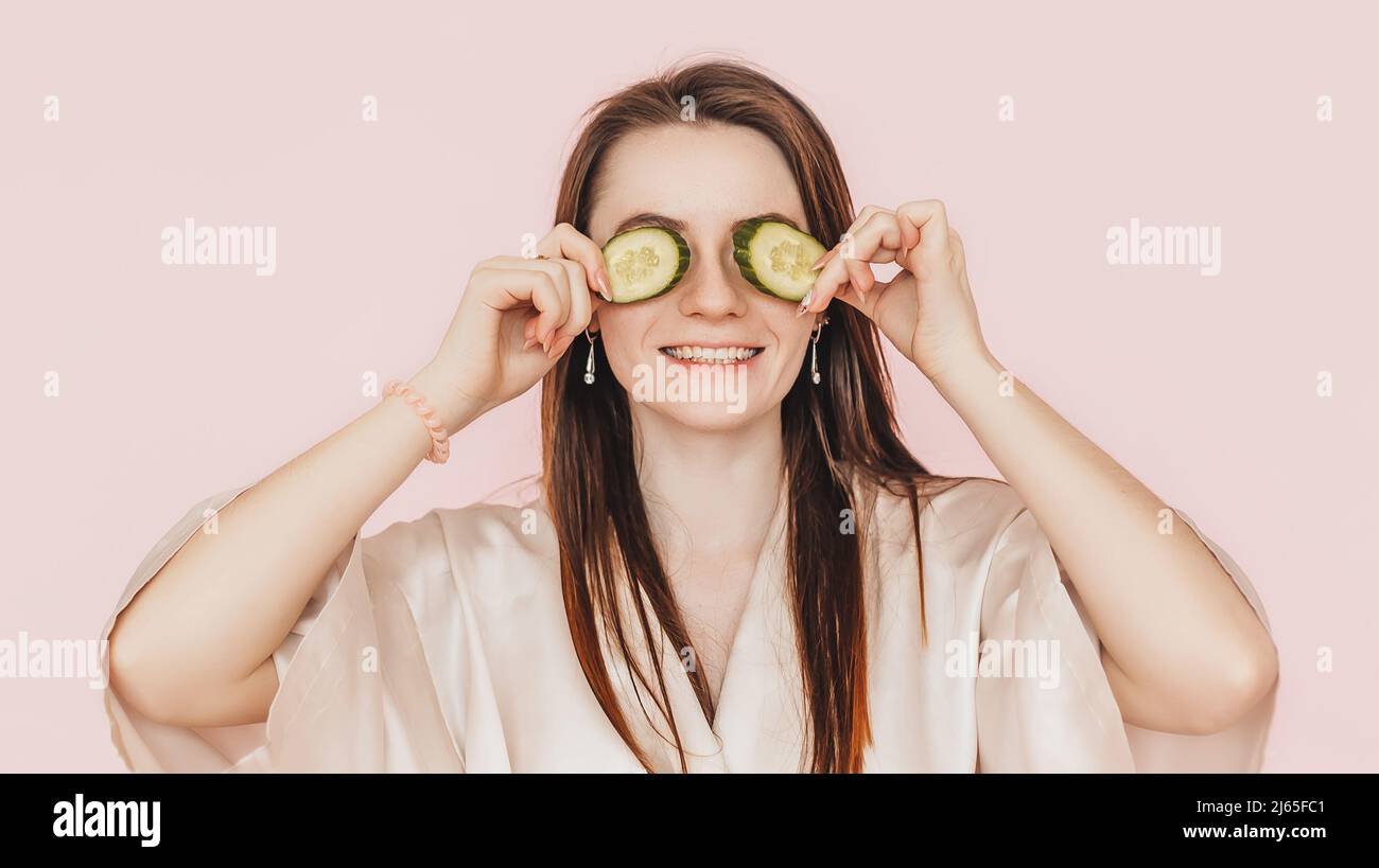 Girl make homemade face beauty masks. Cucumbers for the freshness of