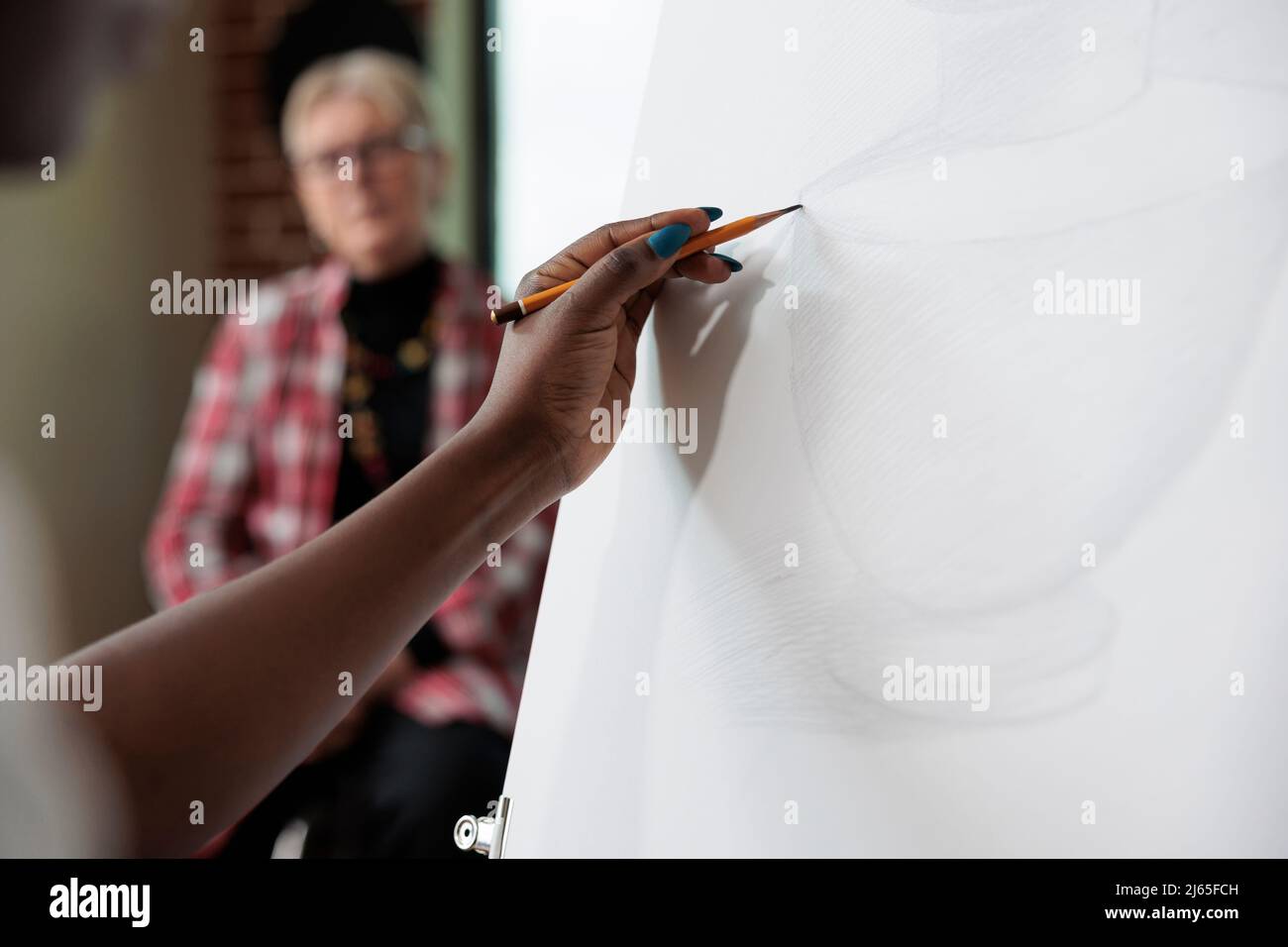 Close up of creative student sketching vase model on canvas working at ...
