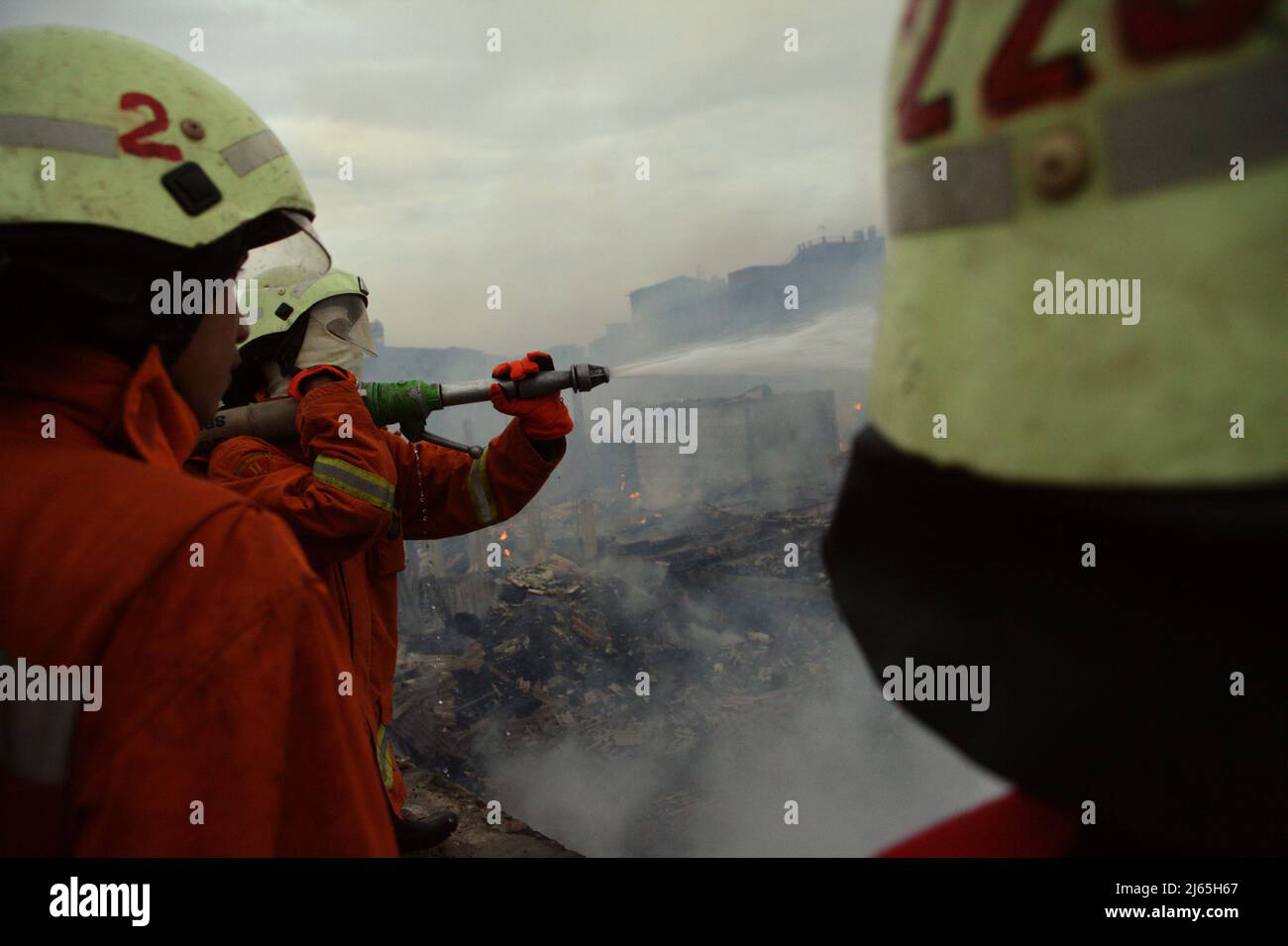 Firefighters Performing The Cooling Phase After A Fire Accident Burned ...