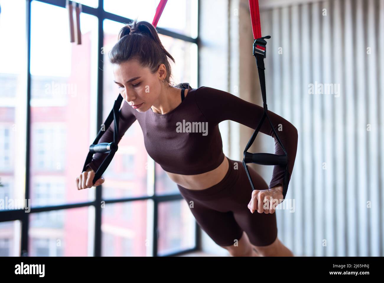 Fit woman doing push-up exercise with trx Stock Photo - Alamy