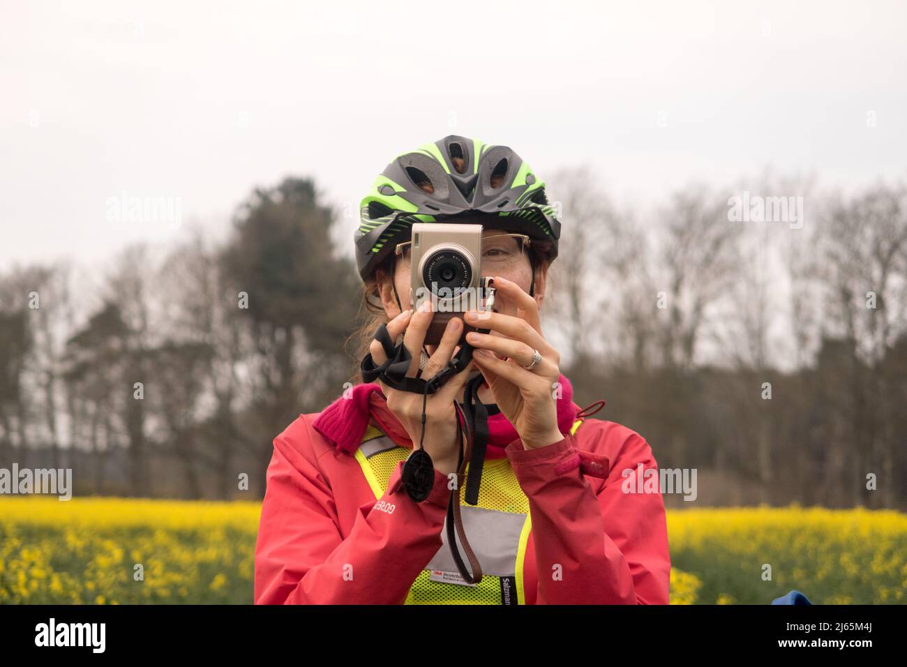 A woman cyclist taking a picture Stock Photo