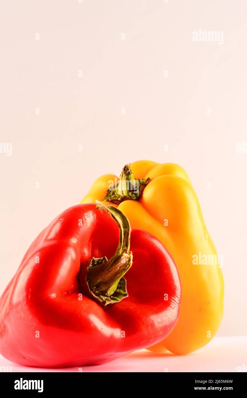 Red and yellow pepper on white background Stock Photo - Alamy
