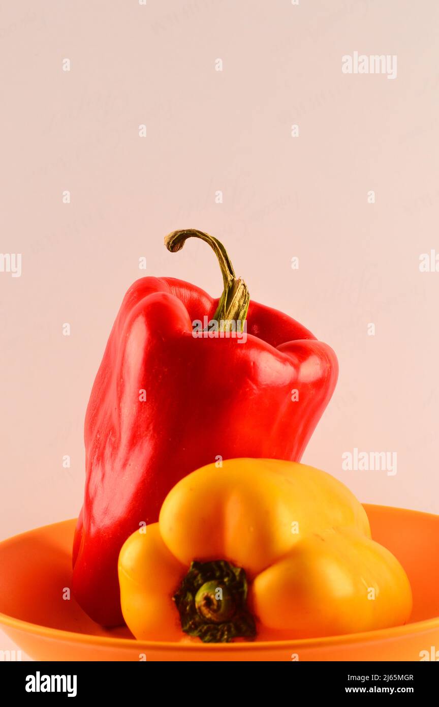 Red and yellow pepper on white background Stock Photo - Alamy