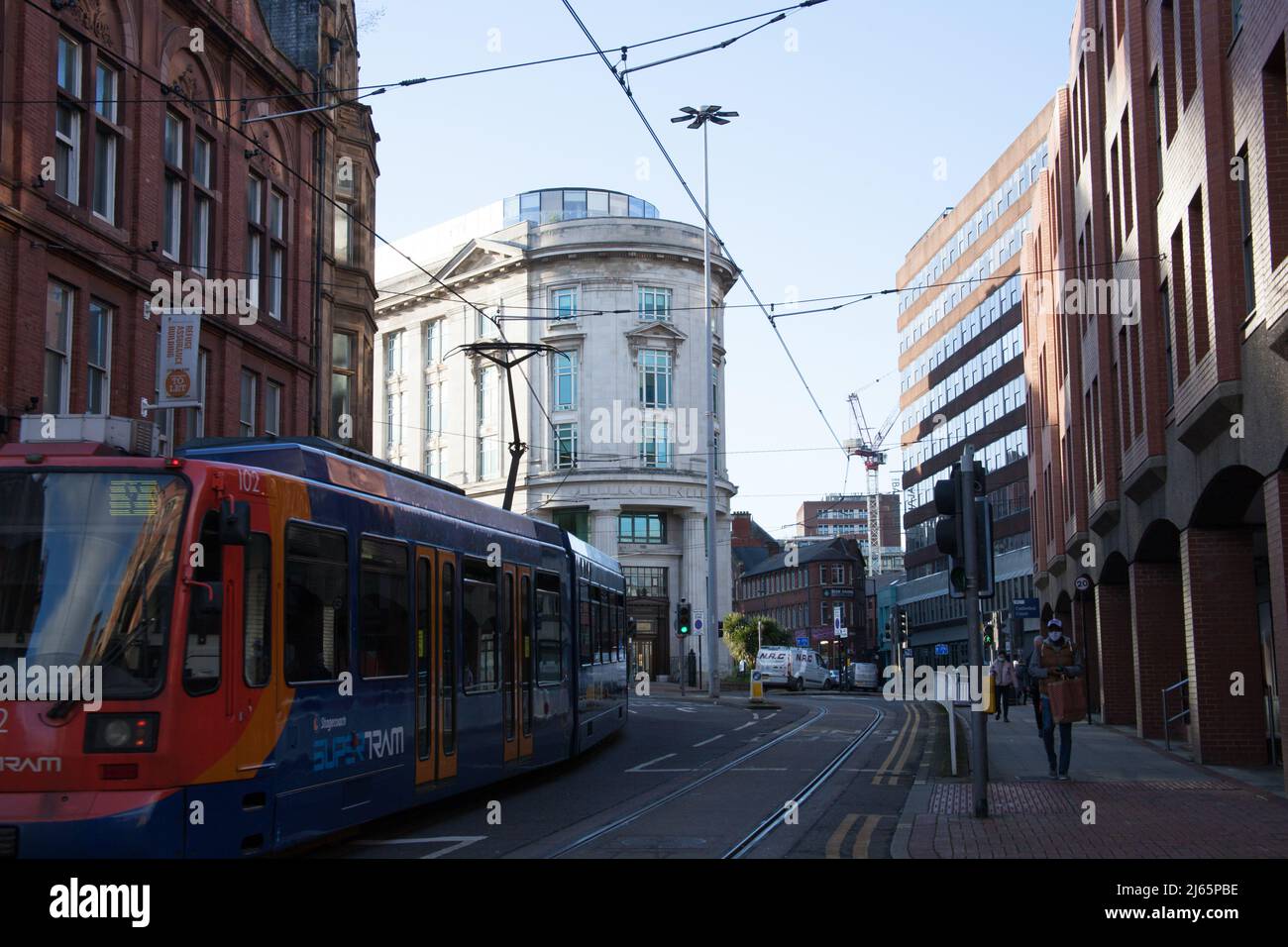 A tram drives through the centre of Sheffield in South Yorkshire in the UK Stock Photo