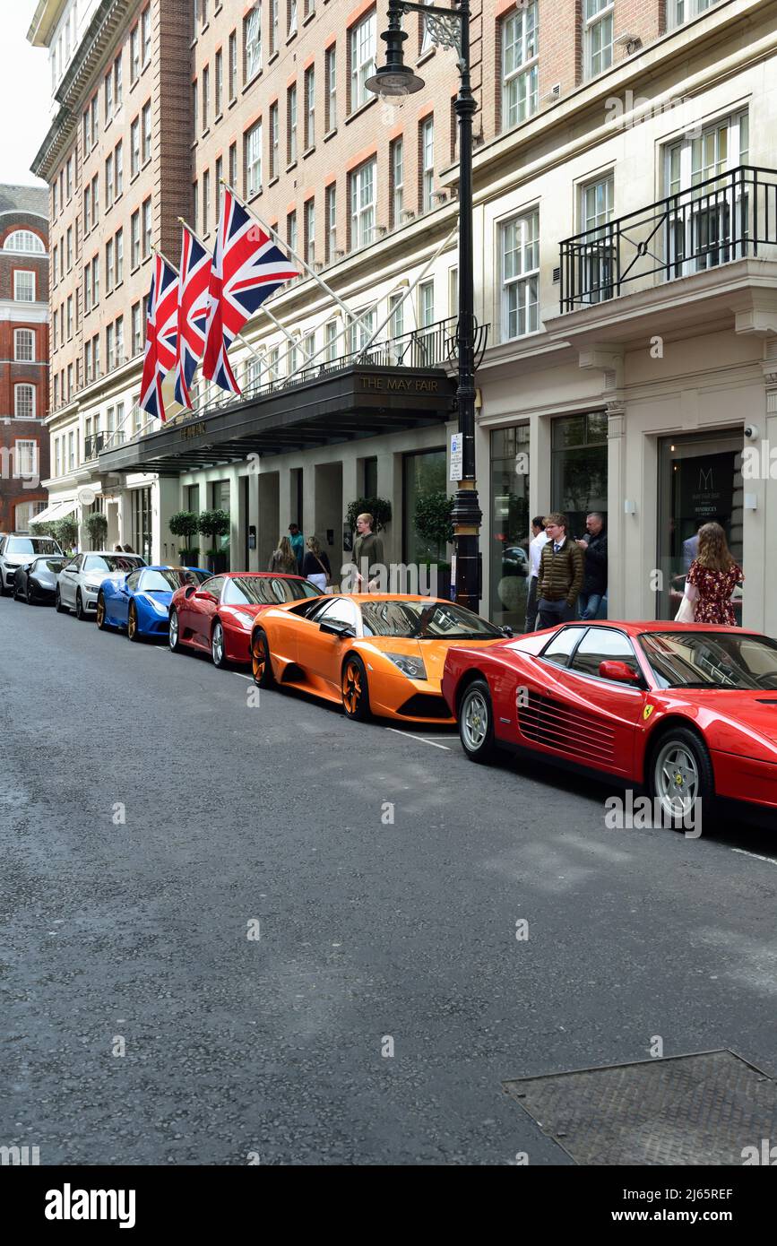 Sports cars outside the May Fair Hotel, Stratton Street, Mayfair, West London, United Kingdom Stock Photo