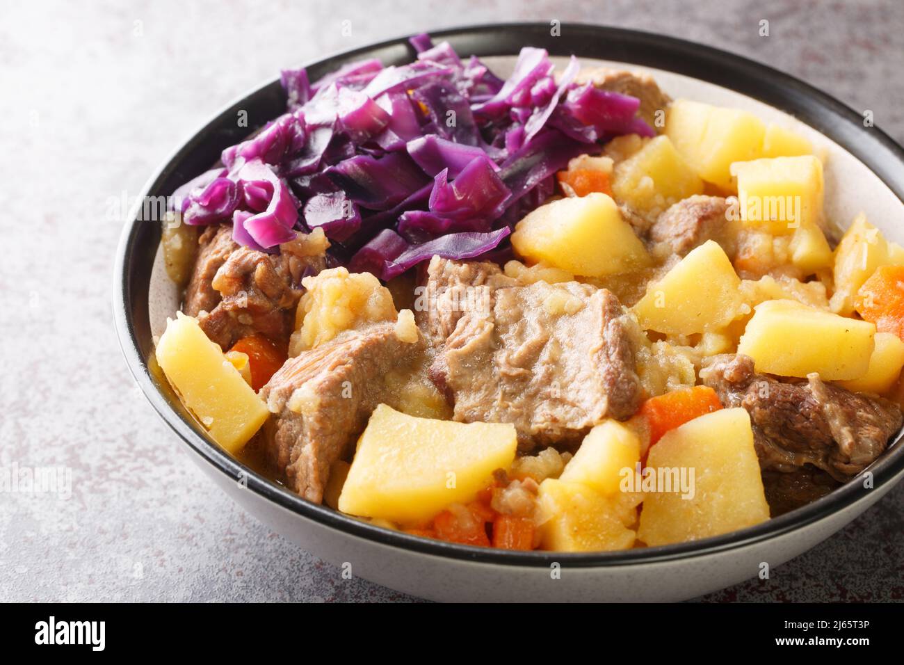 Perfect scouse with meat and vegetables stew from Liverpool close-up in a plate on the table. Horizontal Stock Photo