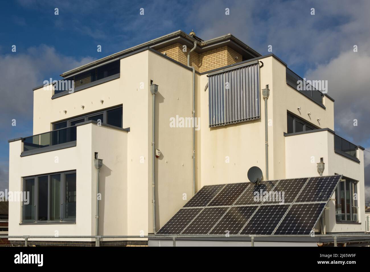 Residential house with solar panels for electricty generation and hot water. Bognor Regis in West Sussex, England Stock Photo