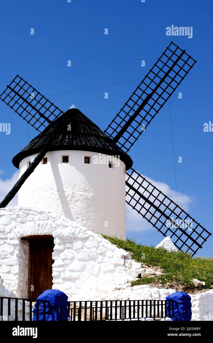 Famous Old Spanish Windmill Cueva Silo in Campo de Criptana against Blue Sky Outdoors. Castilla La Mancha, Spain Stock Photo