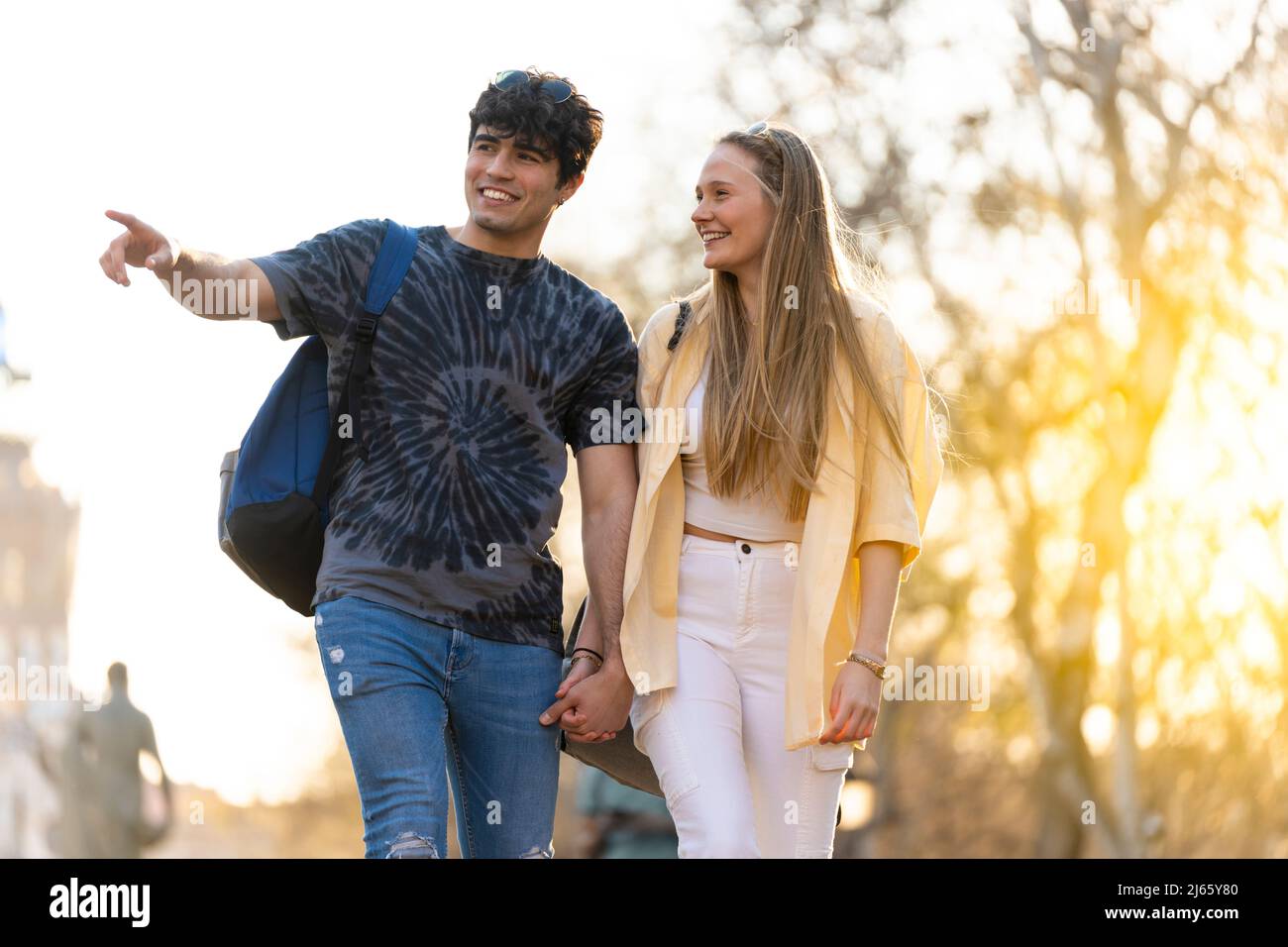 Young heterosexual couple walking in a park and talking Stock Photo