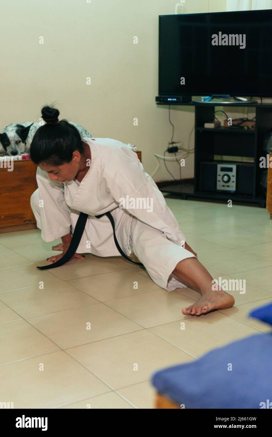 Latin Woman training in a karate class at home Stock Photo