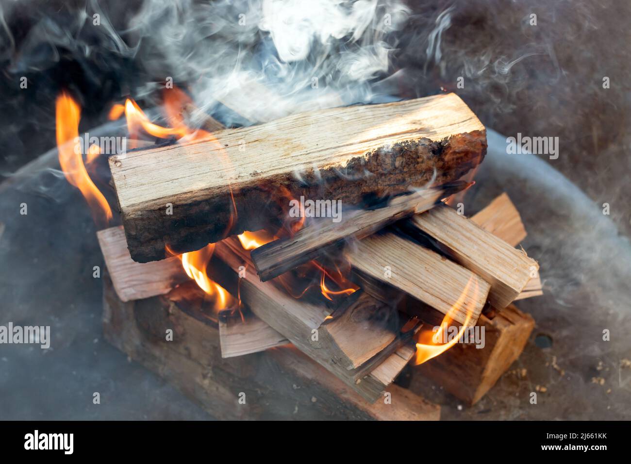 smoke development over burning logs Stock Photo Alamy
