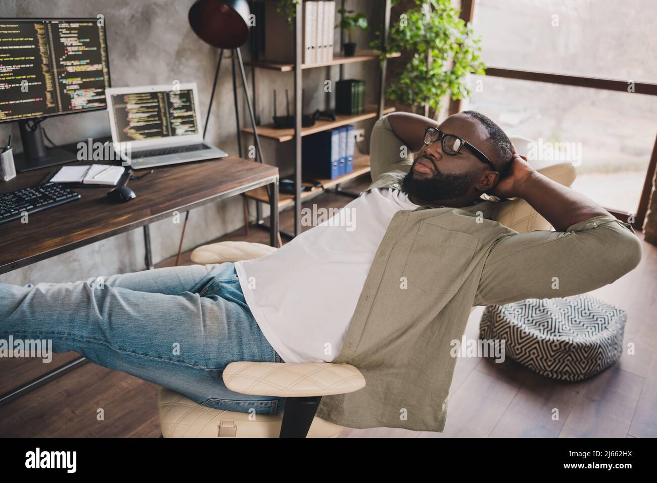 Photo of exhausted guy developer sit chair nap sleep after hardware web java script testing in workspace Stock Photo