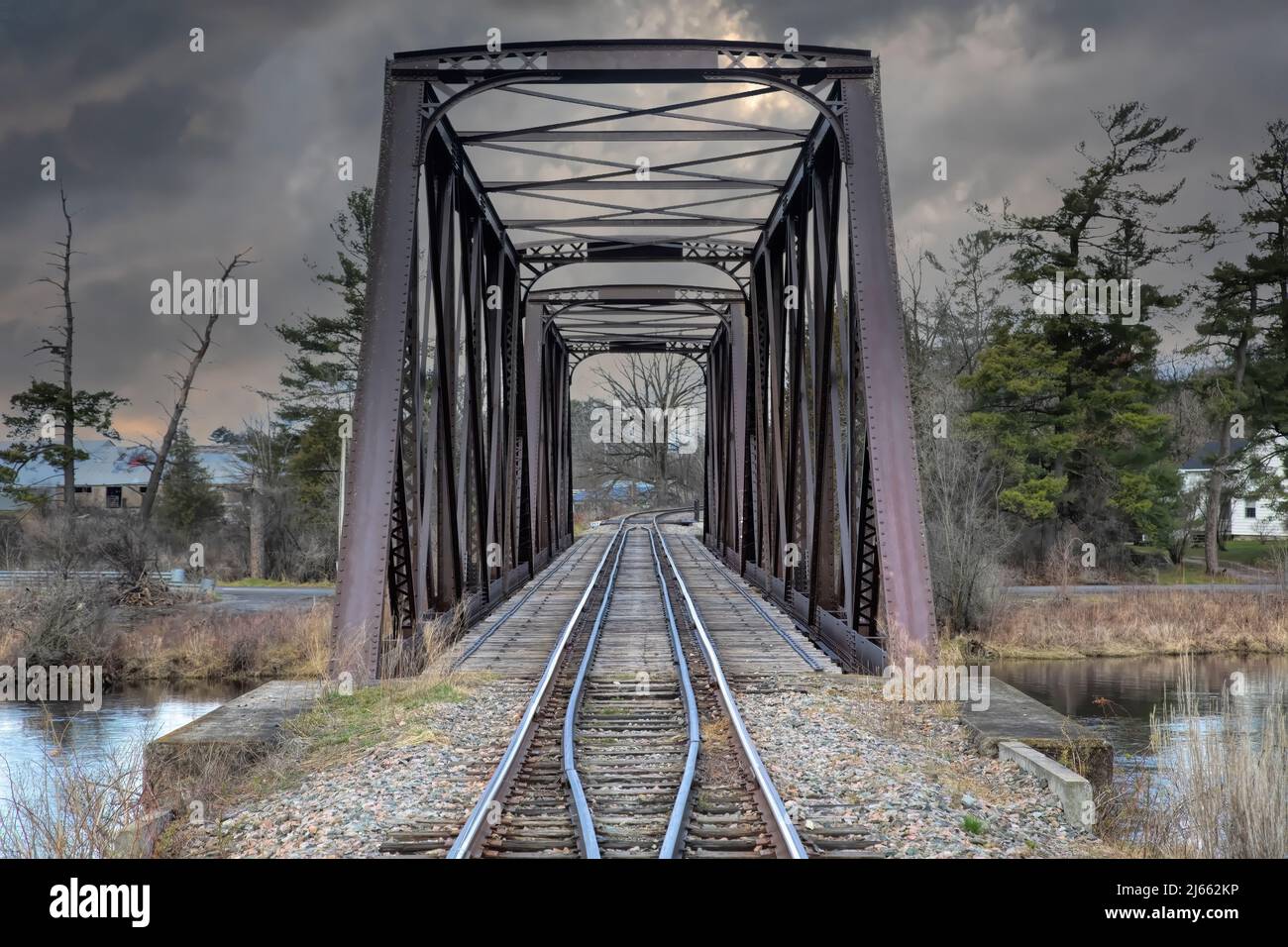 Old iron railway truss bridge built in 1893 crossing the Mississippi river in spring in Galetta, Ontario, Canada Stock Photo