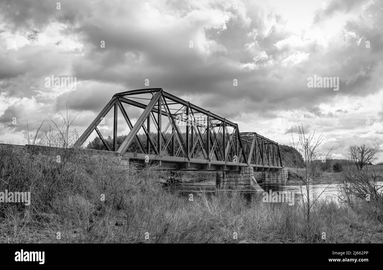 Double span riveted railway truss bridge built in 1893 crossing the Mississippi river in spring in Galetta, Ontario, Canada Stock Photo