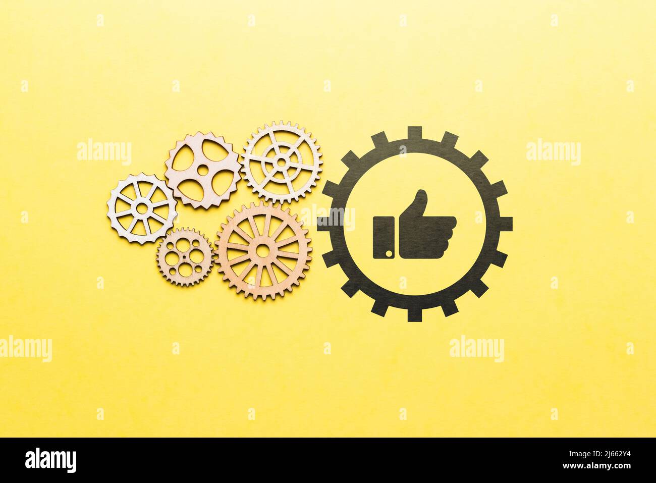 Technology for a set of likes and approvals in social networks. Icon thumbs up with gears Stock Photo