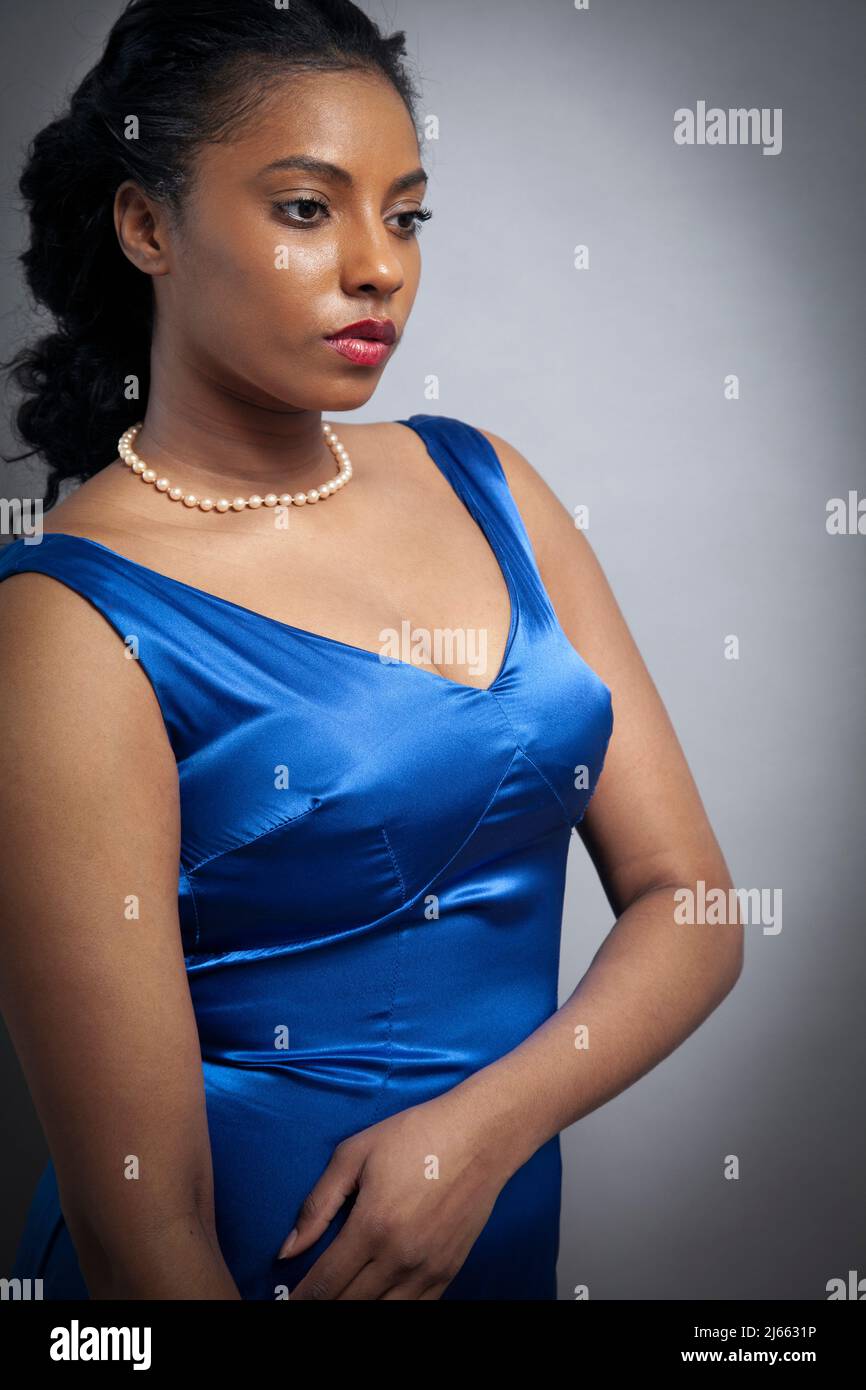 Woman with Pearls in Blue Satin Dress Stock Photo