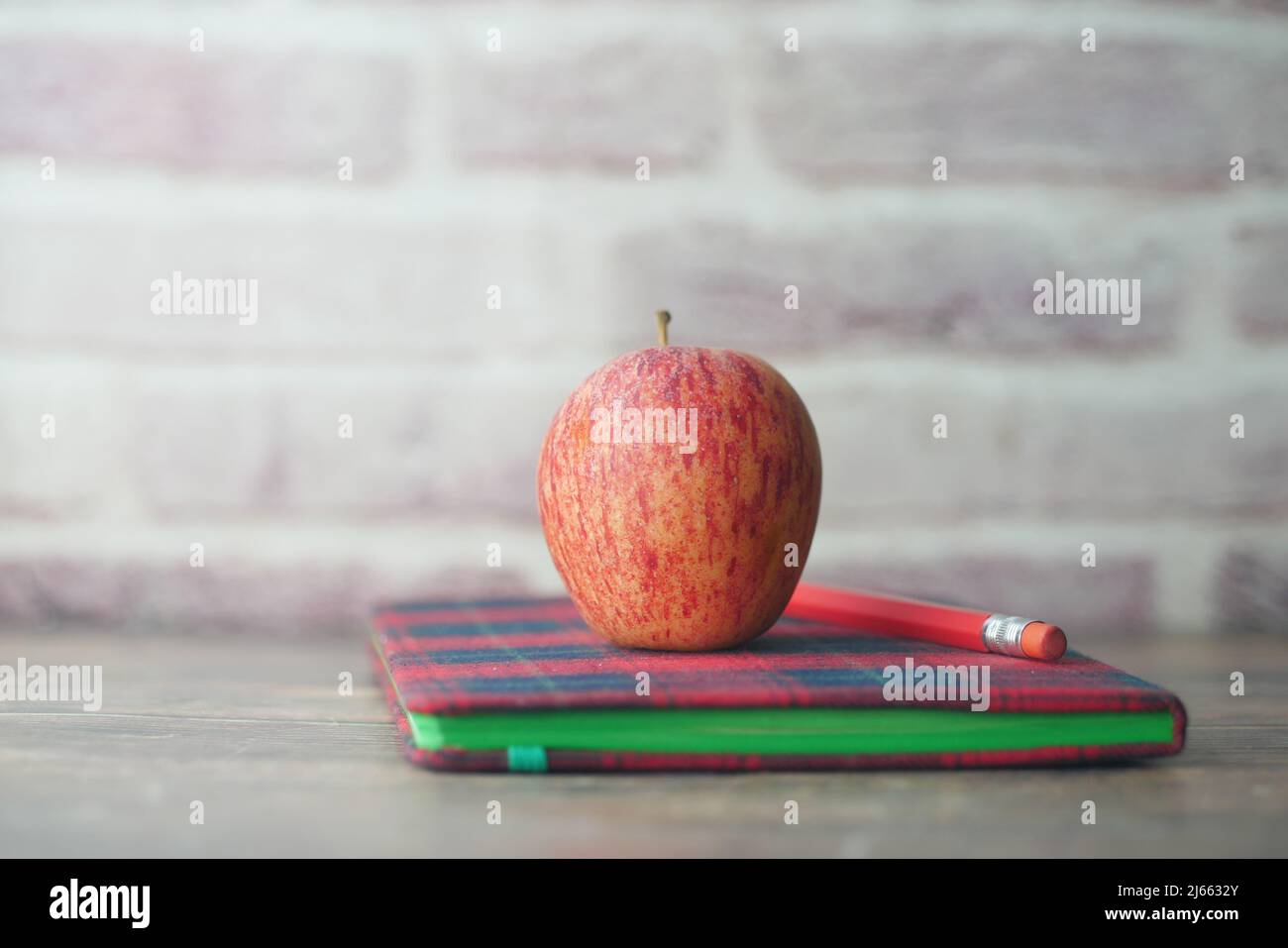 black to school concept with apple on notepad on table. Stock Photo