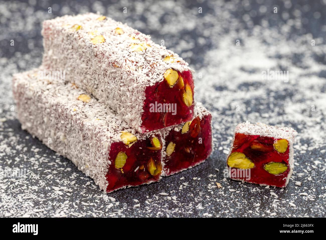 Turkish Delight with Pomegranate and Pistachio Rovings. Traditional Turkish cuisine delicacies. close up Stock Photo