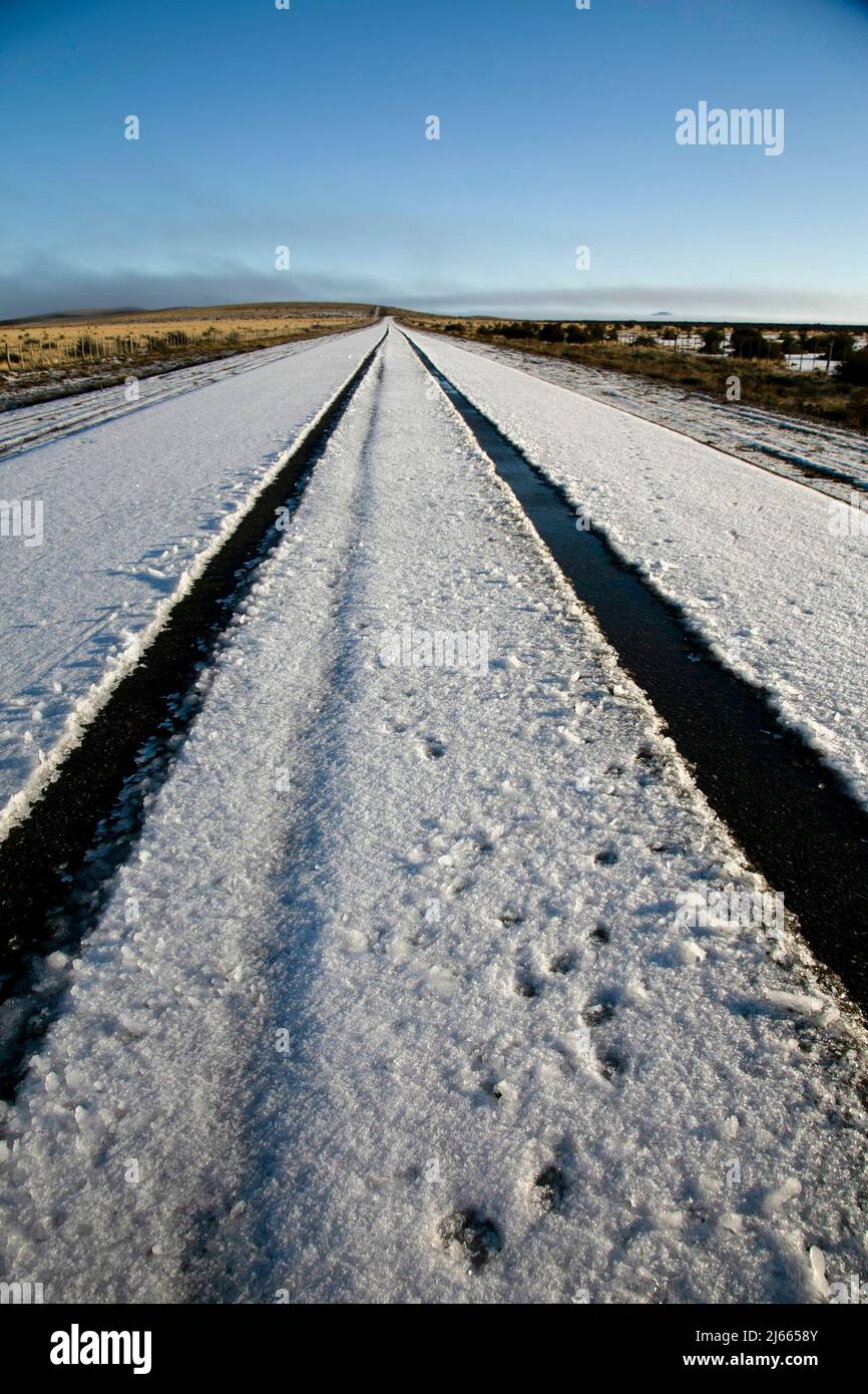 footprints on the snowy road Stock Photo