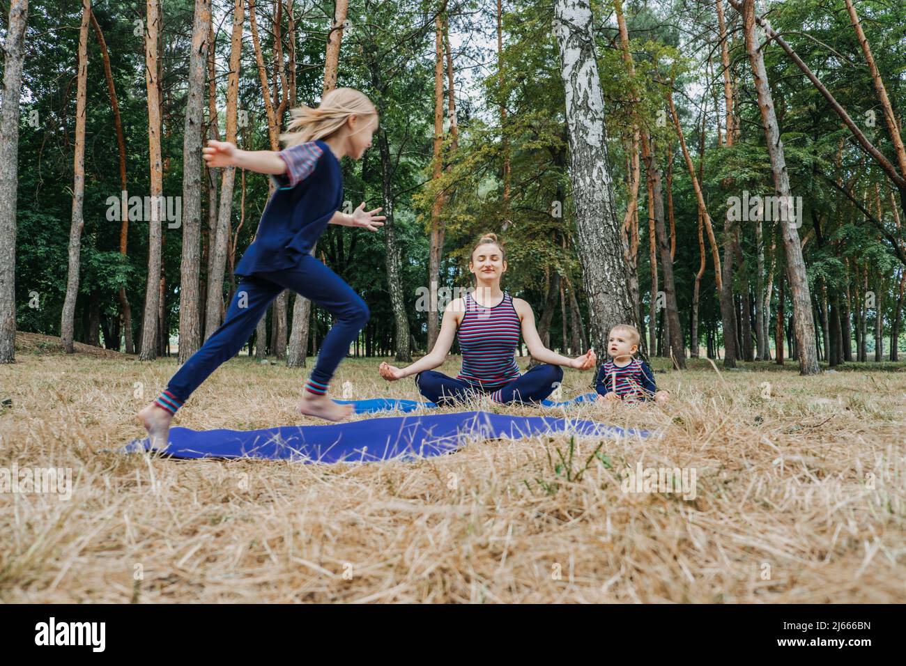 Parents and mental health. Parents zen. Little preschool daughter jumping while her mother doing
