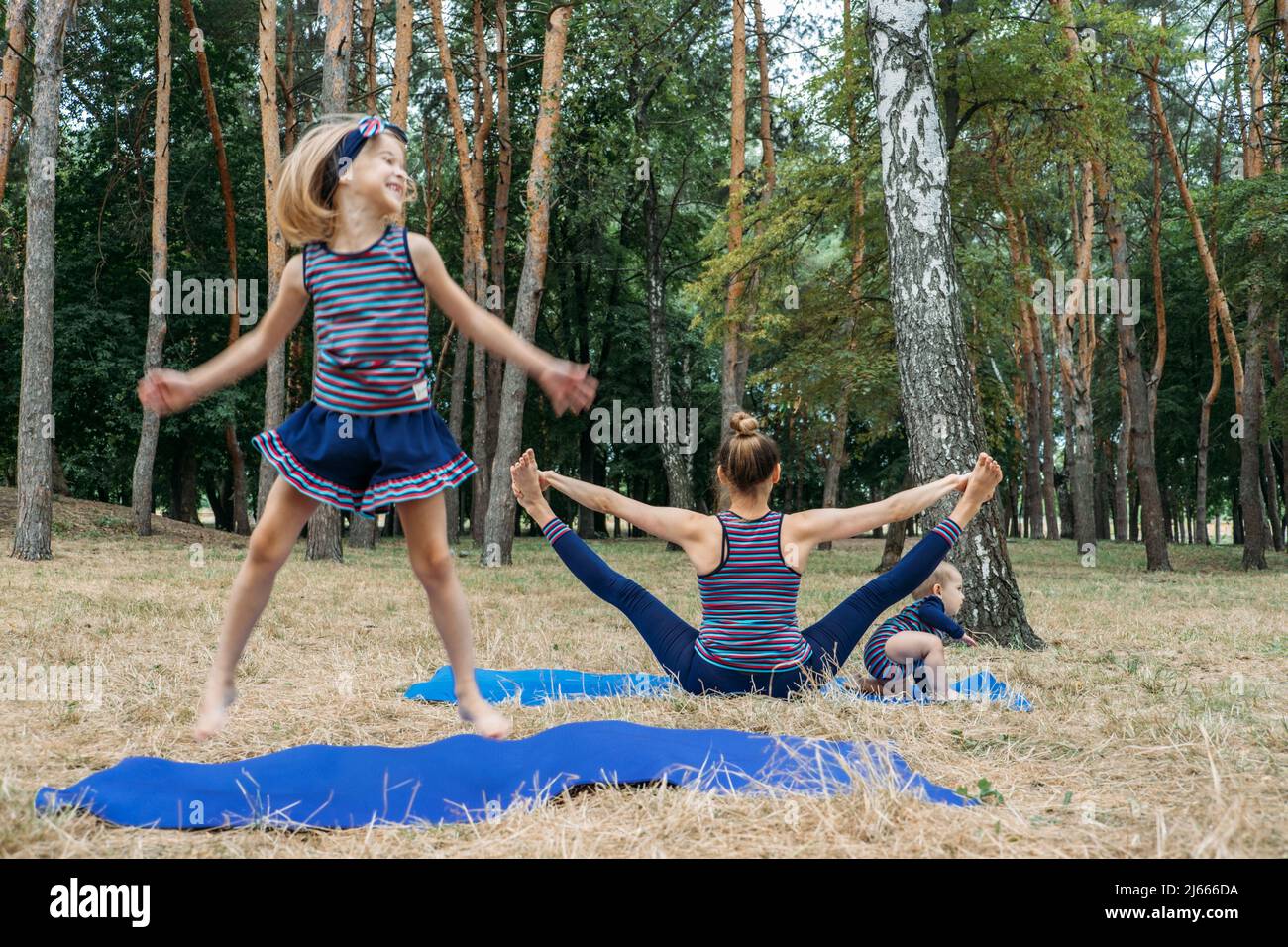 Parents and mental health. Parents zen. Little preschool daughter jumping while her mother doing