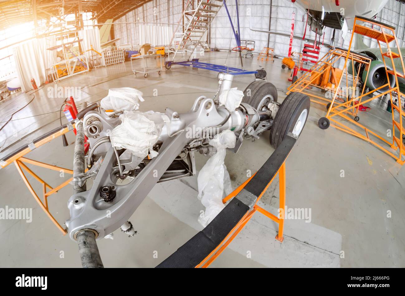 Replacement of the front landing gear at the passenger liner in the hangar, dismantled landing gear Stock Photo