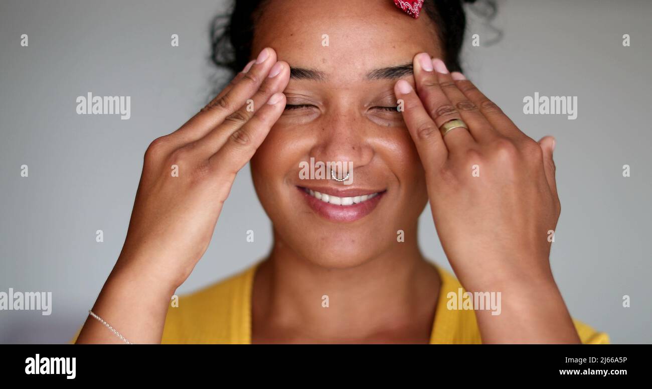 Pensive black woman rubbing face with hands thinking Stock Photo Alamy