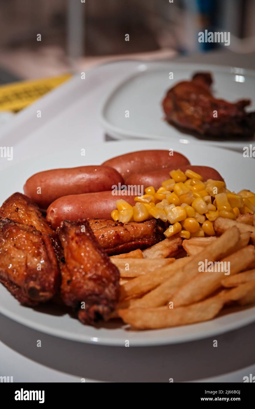 French fries, chicken and sausages, unhealthy fast food meal Stock