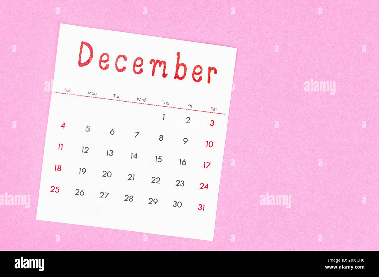 The December 2022 calendar on pink background with empty space. Stock Photo