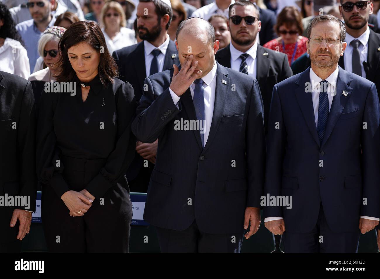 Jerusalem, Israel. 28th Apr, 2022. Israeli Prime Minister Naftali Bennett and his Wife Galit stand still together with President Isaac Herzog during the ceremony marking Holocaust Remembrance Day at Warsaw Ghetto Square at Yad Vashem memorial in Jerusalem, April 28, 2022. Pool Photo by Amir Cohen/UPI Credit: UPI/Alamy Live News Stock Photo