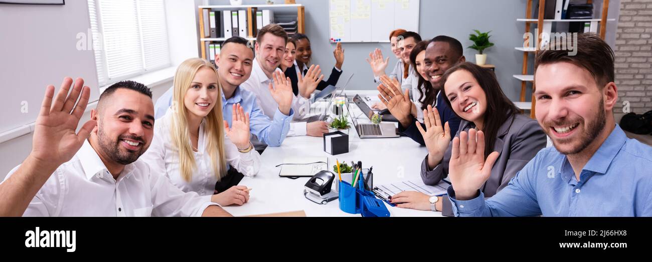 Happy Business Group Of Diverse People Waving Hands During A Meeting Conference In The Office Stock Photo